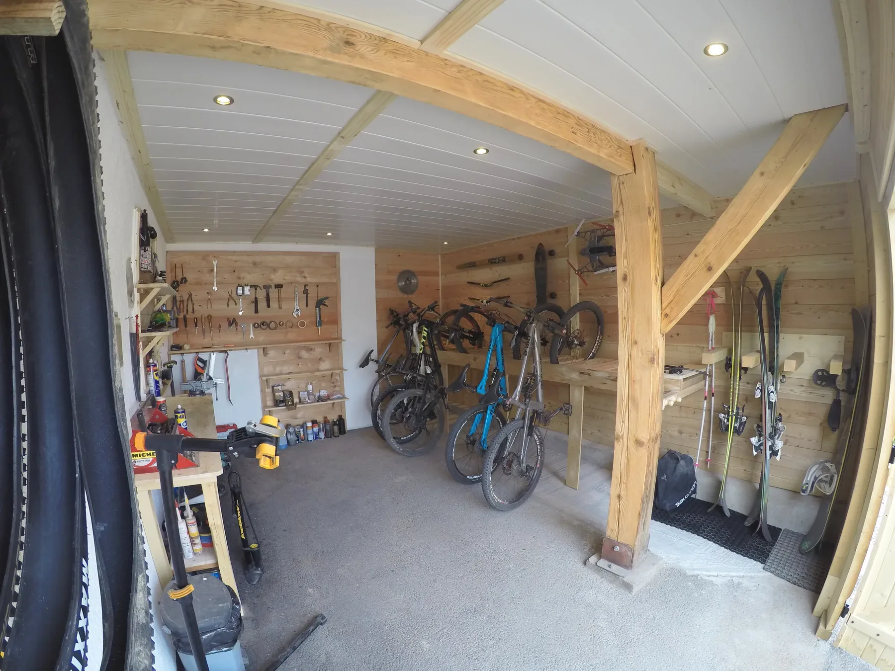 Chalet bike workshop with tools, mountain bikes and equipment storage